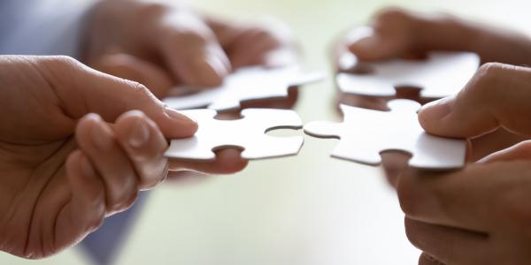 four puzzle pieces coming together