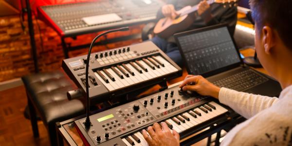 person playing electronic keyboards
