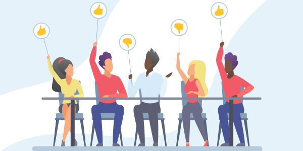 people at a table giving thumbs up or thumbs down