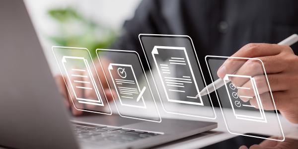 person with digital pen in hand signing virtual documents