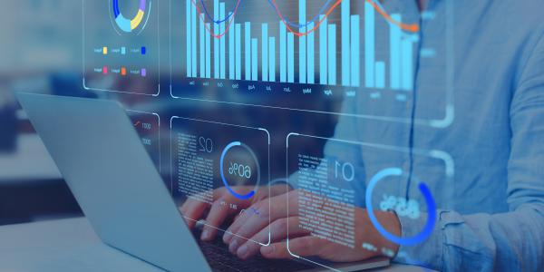 Analyst working on business analytics dashboard with KPI, charts and metrics
