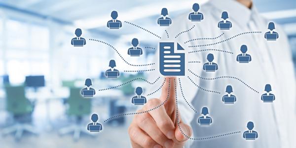  Image of a hand interacting with a virtual network diagram showing interconnected icons representing people and documents, symbolizing document management in a corporate setting.