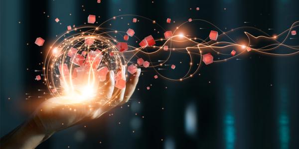 Image of a hand holding a glowing orb with digital connections and floating data cubes, symbolizing global data connectivity and network technology.