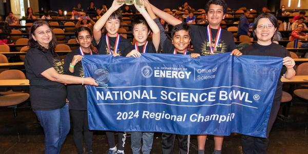 2024 SLAC Regional Middle School Science Bowl participants with banner