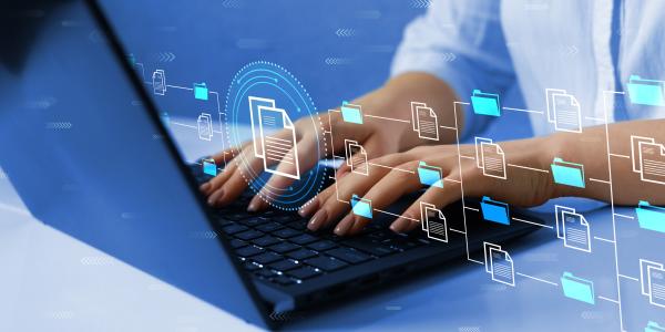 Person typing on laptop with digital overlay of folders and documents representing SLAC's software resource hub