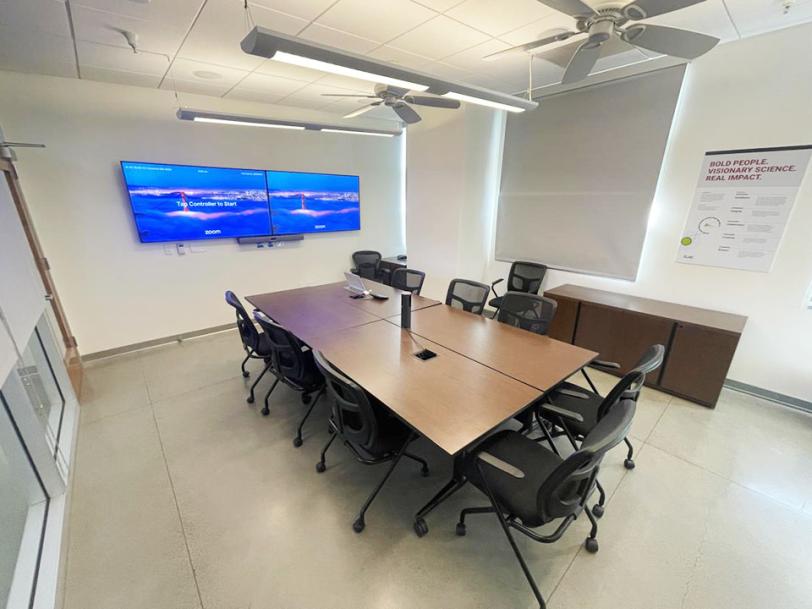 interior view of conference room with tables, chairs, and monitors