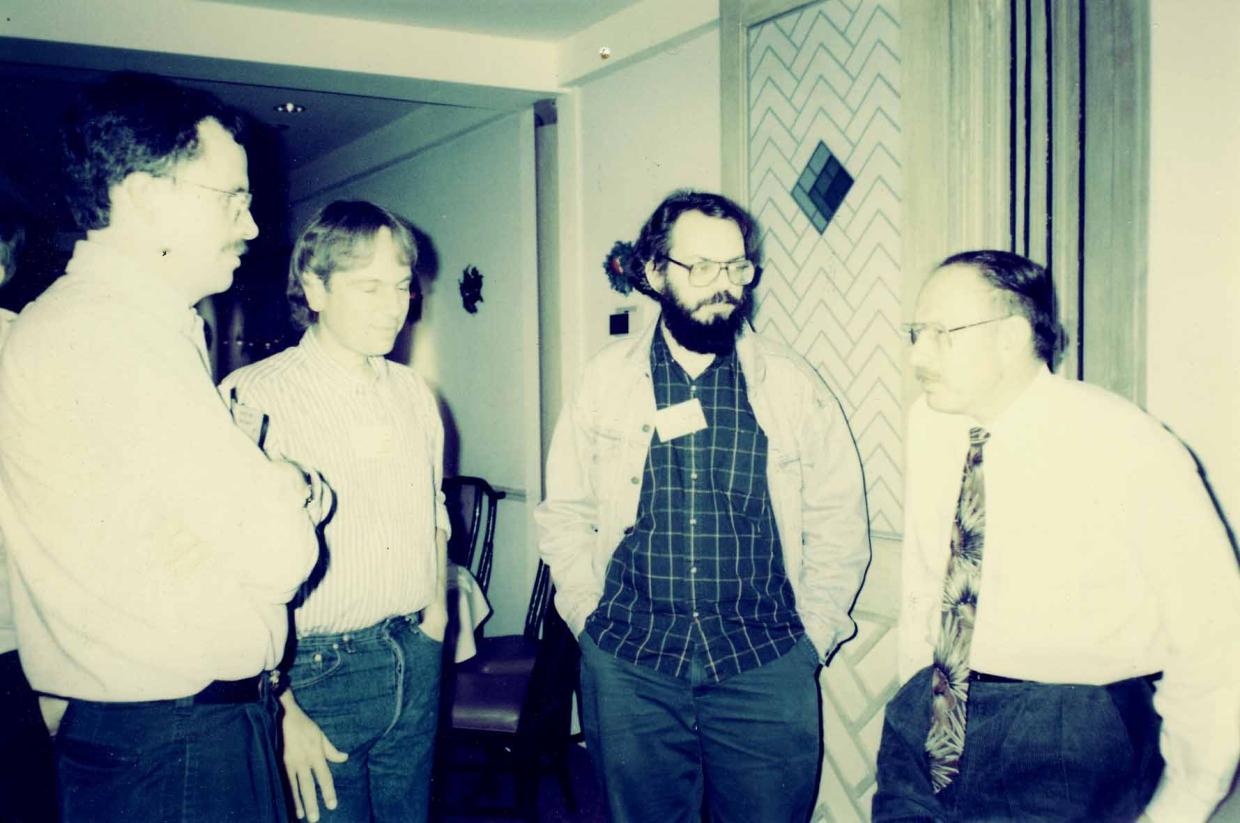 john and colleagues standing and talking