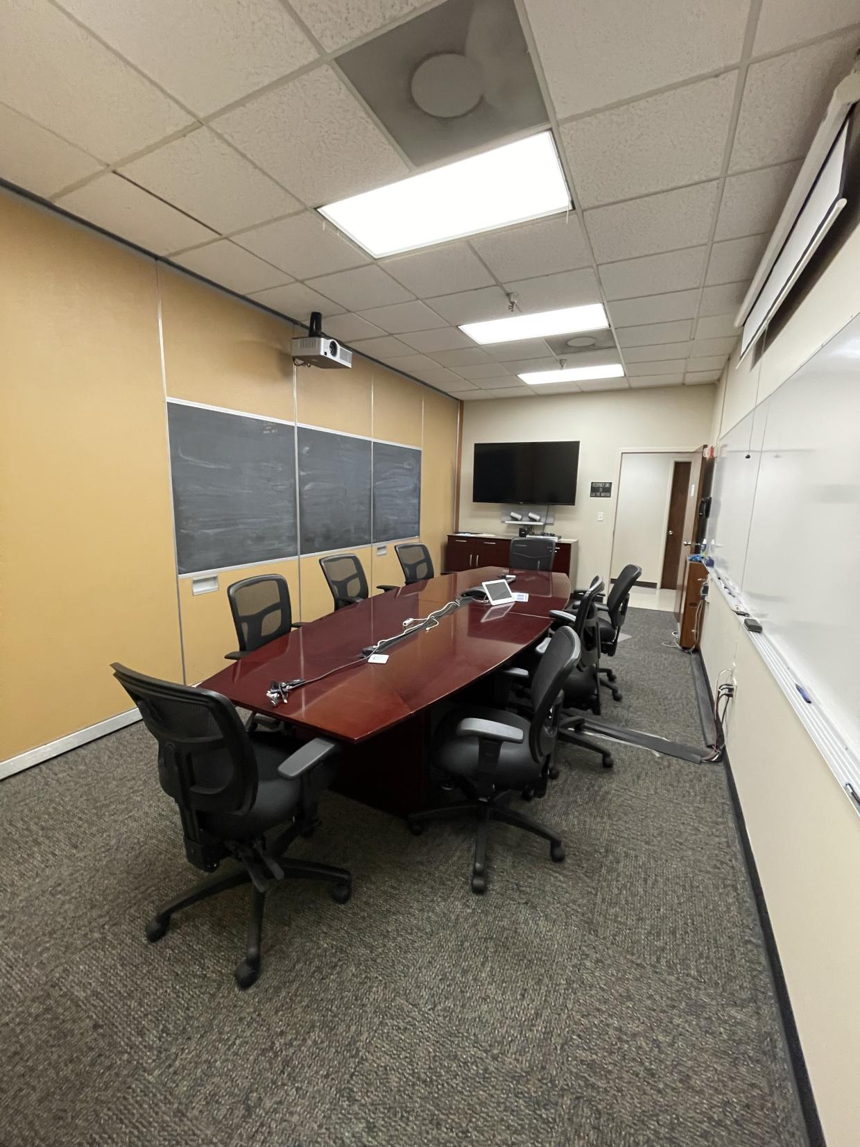 Table , chairs , and display screen