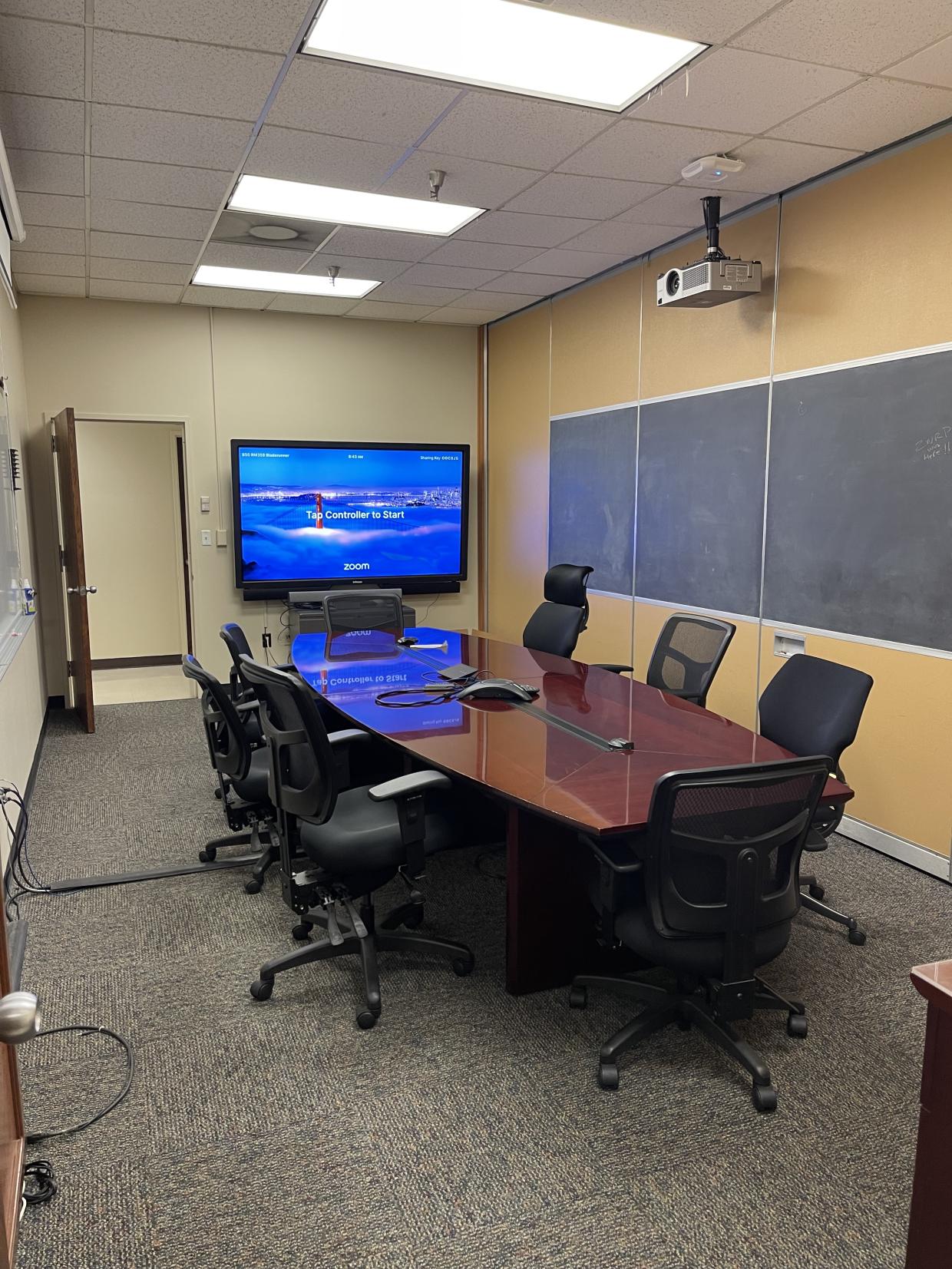 Table , chairs and display screen