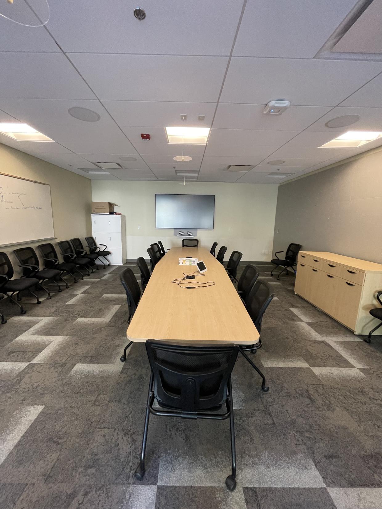 Table , chairs , and display screen