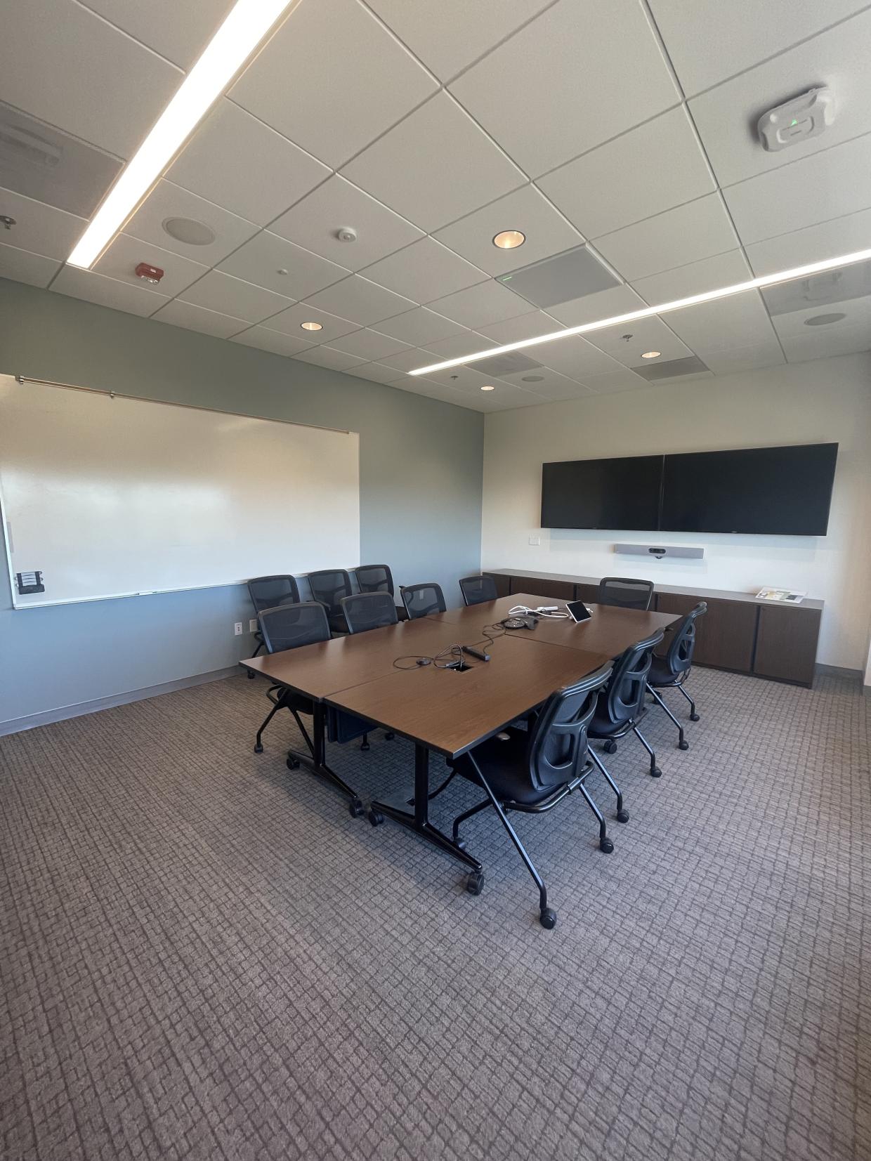Table , chairs, white board and display screen