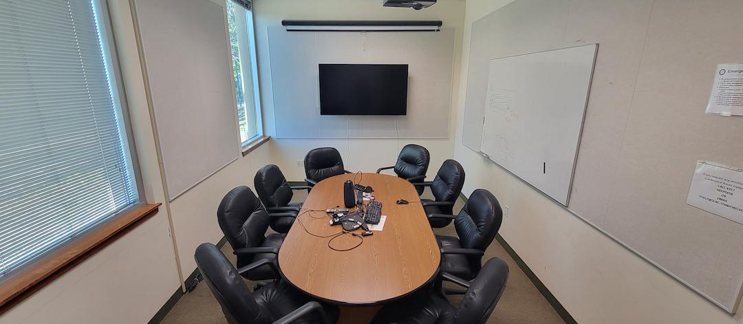 meeting table and chairs, white board, projector & display Tv