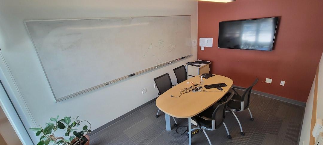 Meeting table , chairs , white board and display TV