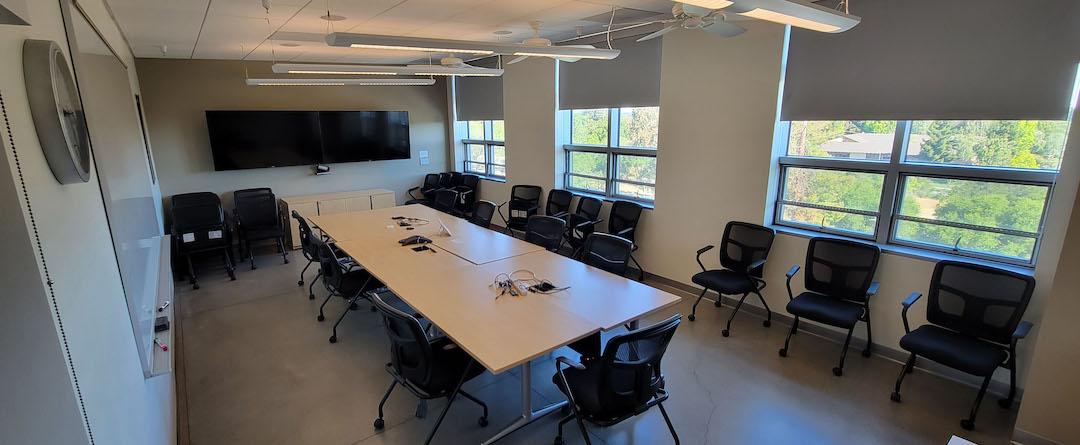 table , chairs , two display screens 