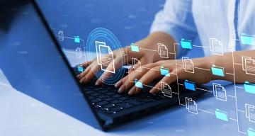 Person typing on laptop with digital overlay of folders and documents representing SLAC's software resource hub